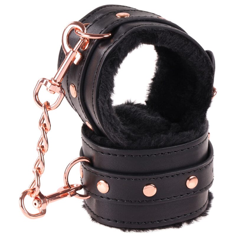 Black padded cuffs with rose-gold hardware from the Sex & Mischief Brat Kit